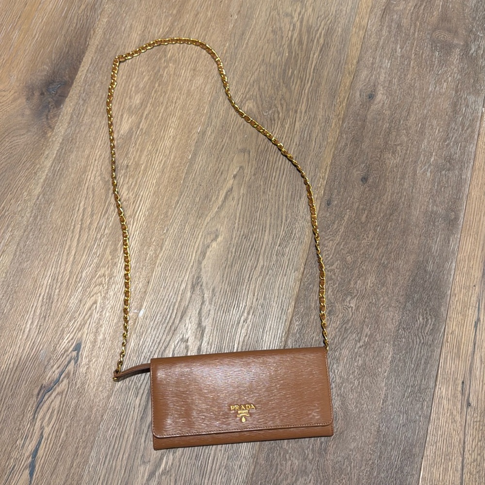 Prada wallet in a chain